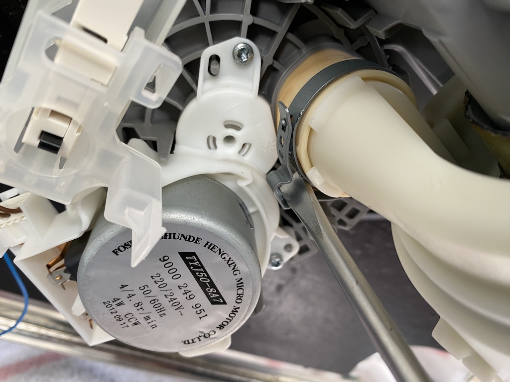 Twisting open the hose clip with a screwdriver.